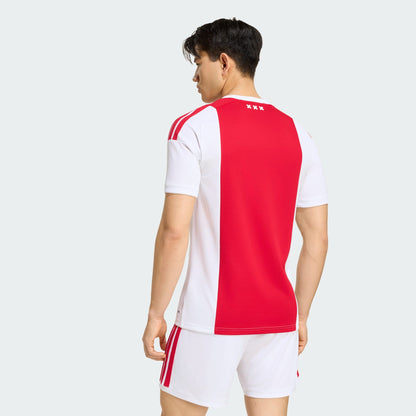 Adidas Ajax Amsterdam thuistenue voetbalshirt 2026 2027 met officiële clubdetails op model Kickoff Antwerpen