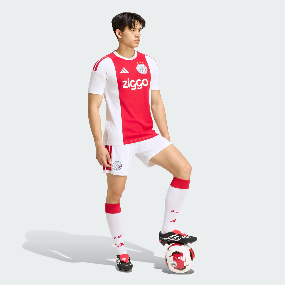 Adidas Ajax Amsterdam thuistenue voetbalshirt 2026 2027 met officiële clubdetails op model Kickoff Antwerpen