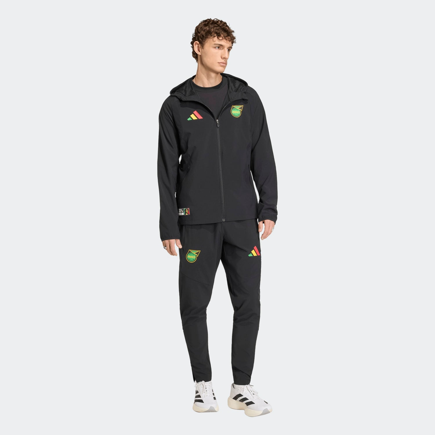 Zwarte Adidas JFF Jamaica Tracksuit Pants met geel-groene details, ode aan Bob Marley, verkrijgbaar bij voetbalshop Kickoff Antwerpen