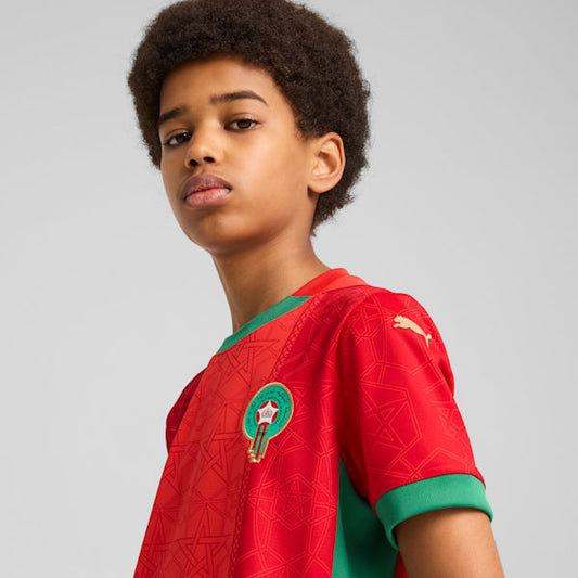 Puma Home Jersey Junior Marokkaans voetbalelftal 2025 met DryCELL-technologie, verkrijgbaar bij Kickoff Antwerpen – rood design met officiële teamdetails.